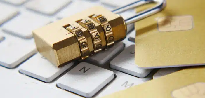 a golden padlock sitting on top of a keyboard