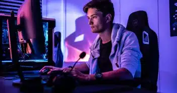 a man sitting in front of a computer monitor